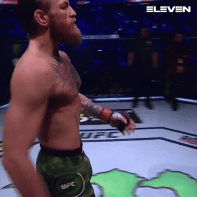 Man Without Shirt Holding Boxing Glove GIF