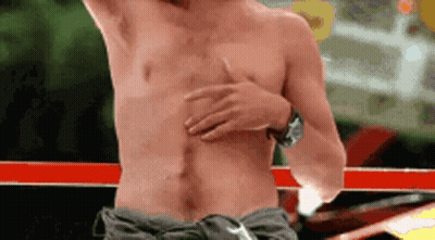 Man Without Shirt Holding Chest In Boxing Ring GIF
