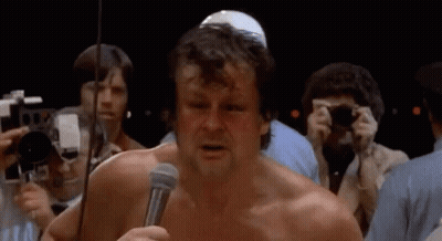Man Without Shirt Holding Microphone GIF