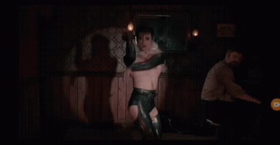 Man Without Shirt In Feathered Collar And Gloves GIF