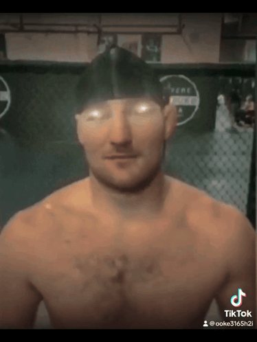 Man Without Shirt In Front Of Fence GIF