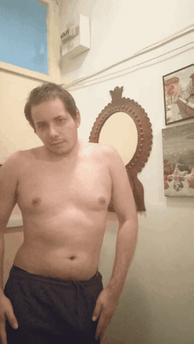 Man Without Shirt In Front Of Mirror And Eee Box GIF