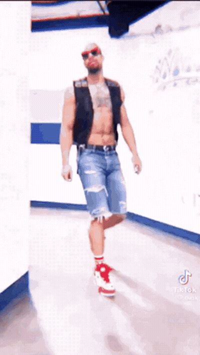 Man Without Shirt In Hallway Wearing Red Shoes And Sunglasses GIF