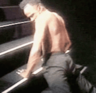 Man Without Shirt Kneeling On Piano GIF