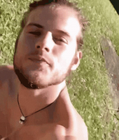 Man Without Shirt Laying In Grass GIF