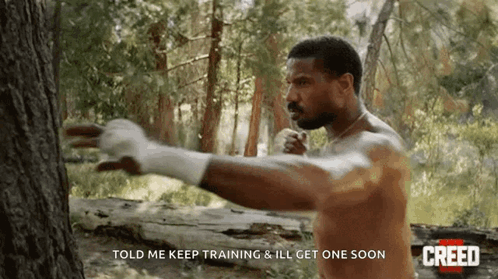 Man Without Shirt Next To Tree GIF