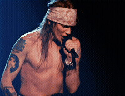 Man Without Shirt Singing Into Microphone GIF