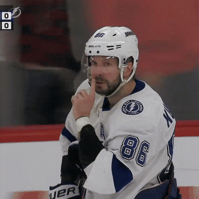 Man Without Shirt Sitting At Table In Front Of Champions Wall GIF