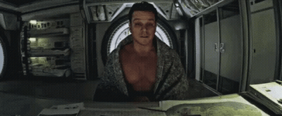 Man Without Shirt Sitting At Table GIF