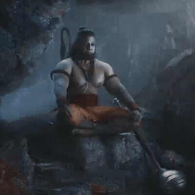 Man Without Shirt Sitting On Rock With Sword GIF