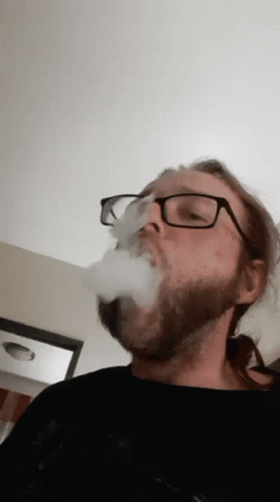 Man Without Shirt Smoking Cigarette Outdoors GIF