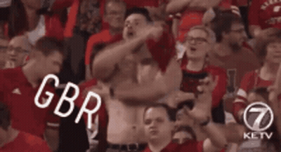 Man Without Shirt Standing In Crowd GIF