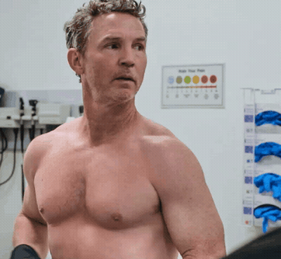 Man Without Shirt Standing In Front Of App Your Pain Sign GIF