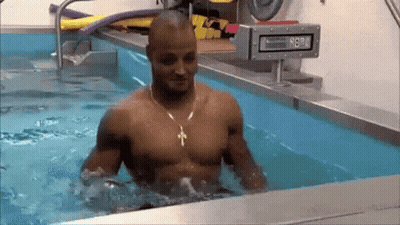 Man Without Shirt Standing In Pool Of Water GIF