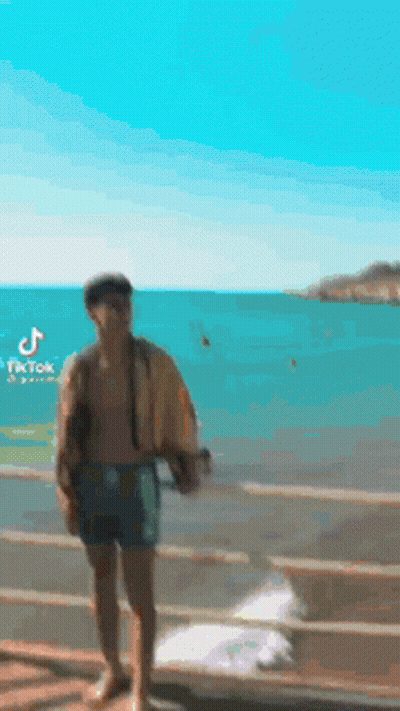 Man Without Shirt Standing On Dock GIF