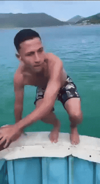 Man Without Shirt Standing On Dock GIF