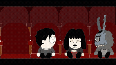 Man Woman And Stuffed Animal In Theater GIF