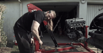 Man Working On Car Engine With Red Crane GIF