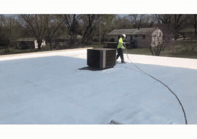 Man Working On Roof With Hose Attached GIF