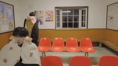Man Wrapped In Blanket In Front Of Window GIF