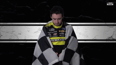 Man Wrapped In Checkered Flag In Ford Racing Uniform GIF