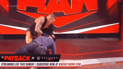 Man Wrestling Another Man On Stage With Payback Sign GIF