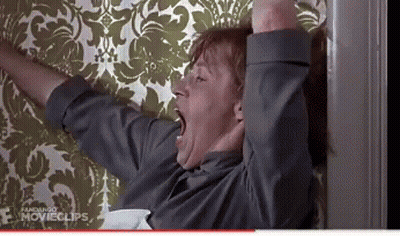 Man Yawning In Front Of Floral Wallpaper GIF