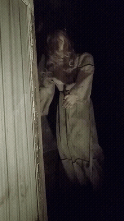 Mannequin In White Dress In Dark Doorway GIF