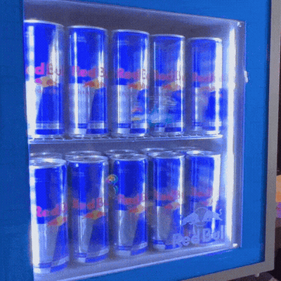 Many Cans Of Red Bull Are Lined Up In A Cooler GIF