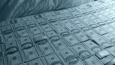 Many Stacks Of 100 Dollar Bills Are Laying On A Bed GIF