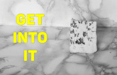 Marble Surface Saying Get Into It In Yellow GIF