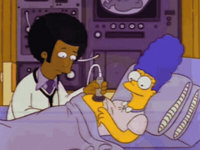 Marge Simpson Laying In Hospital Bed Examined By Doctor GIF