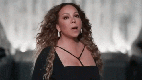 Mariah Carey In Black Dress And Hoop Earrings Singing GIF