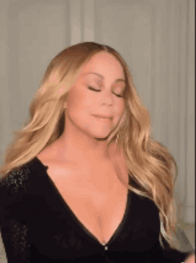 Mariah Carey In Black Plunging Dress With Earrings GIF