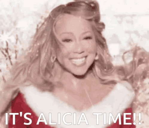 Mariah Carey Is Wearing A Santa Outfit And Smiling With The Words It 'S Alicia Time Written Below Her GIF
