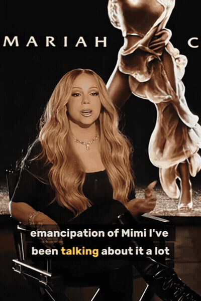 Mariah Poster In Front Of Mimi Statue GIF