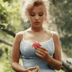 Marilyn Monroe Holding A Flower Petal GIF