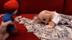 Mario Looking To Puppet Laying On Cash GIF