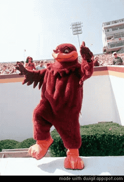 Mascot Giving Thumbs Up In Front Of Stadium GIF