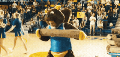 Mascot Holding Log on Basketball Court
