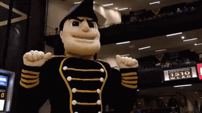 Mascot In Black And Gold Uniform In Front Of 1510 WLAC Sign GIF