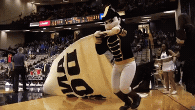 Mascot In Black And Gold Uniform In Front Of 1510 WLAC Sign GIF
