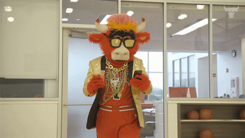 Mascot In Bull Costume Looking At Cell Phone GIF