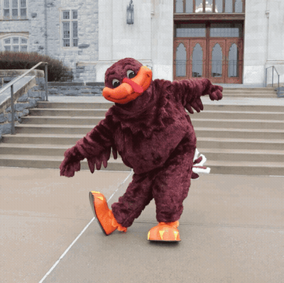 Mascot In Front Of Building With Stairs GIF
