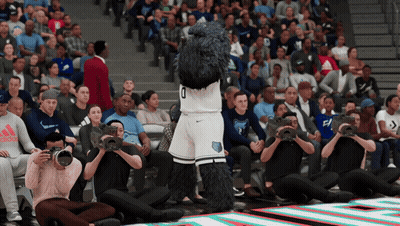 Mascot in Number 0 Jersey Standing in Front of Crowd
