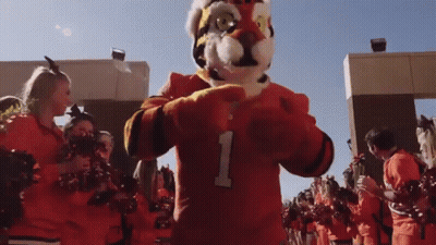 Mascot In Number 1 Jersey With Cheerleaders GIF
