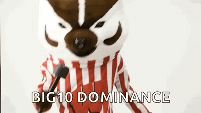 Mascot In Red And White Striped Shirt Holding Microphone Saying Big 10 Dominance GIF