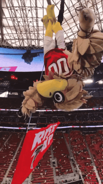 Mascot In Stadium With Pizza Hut Banner GIF