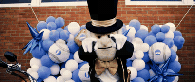 Mascot In Top Hat Surrounded By NCAA Balloons GIF
