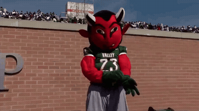 Mascot In Valley 23 Jersey In Front Of Brick Wall GIF
